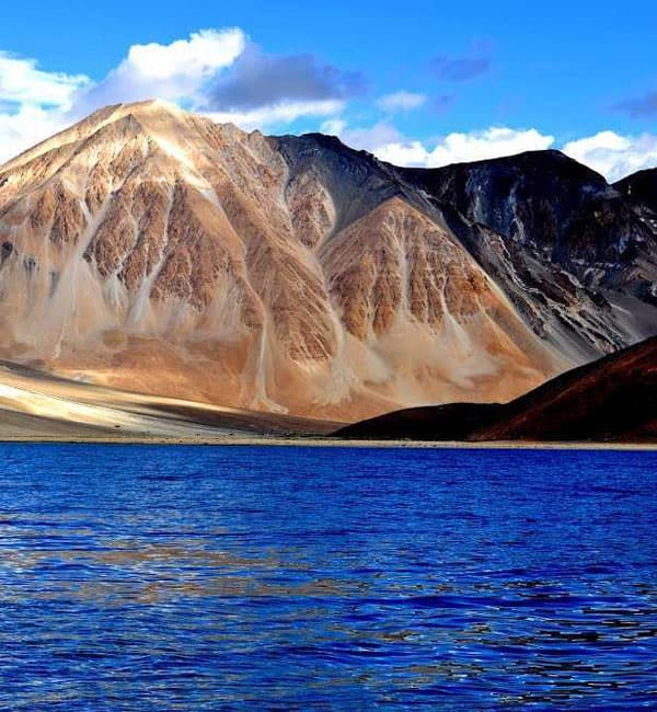 A still lake surrounded by Ladakh's mountains